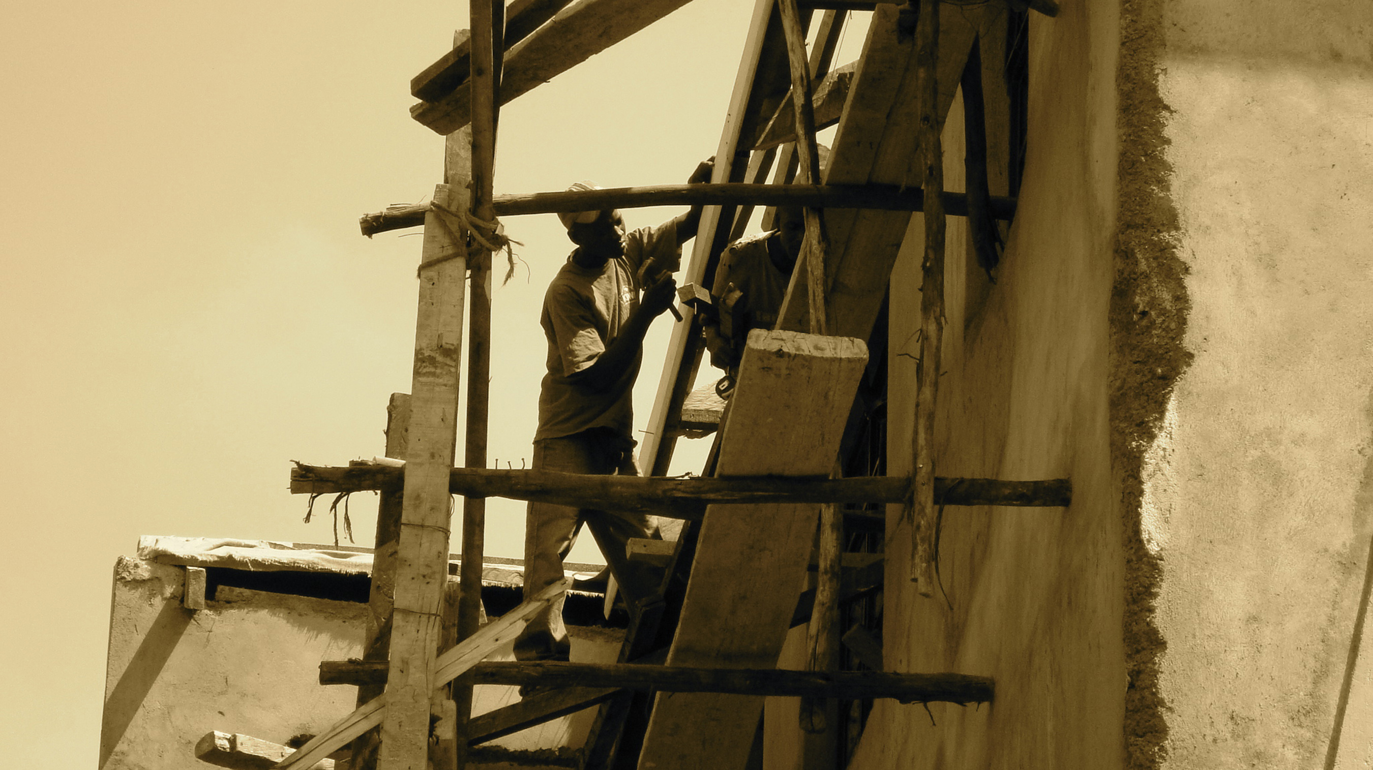 Man on scaffolding in Africa - Bak2Buks Media